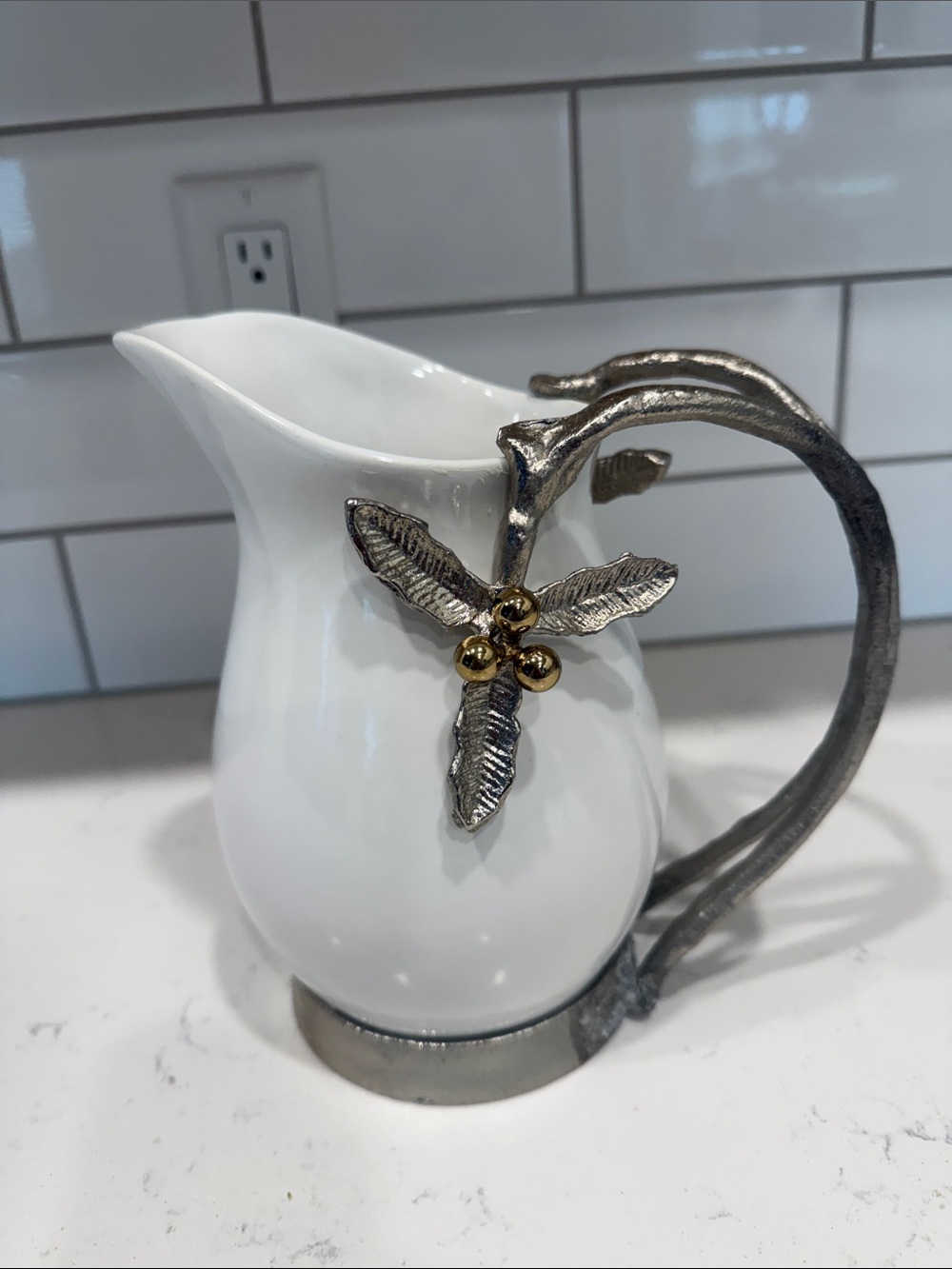 White Ceramic Pitcher with Decorative Metal Handle and Leaf Accent